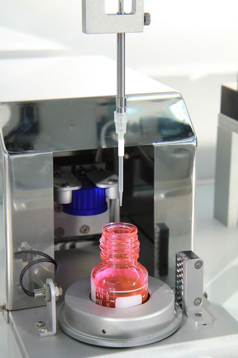 dispense with disposable tip and pink liquid